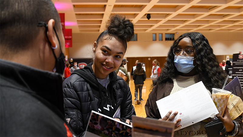 Student and family member learning about St. Cloud State University