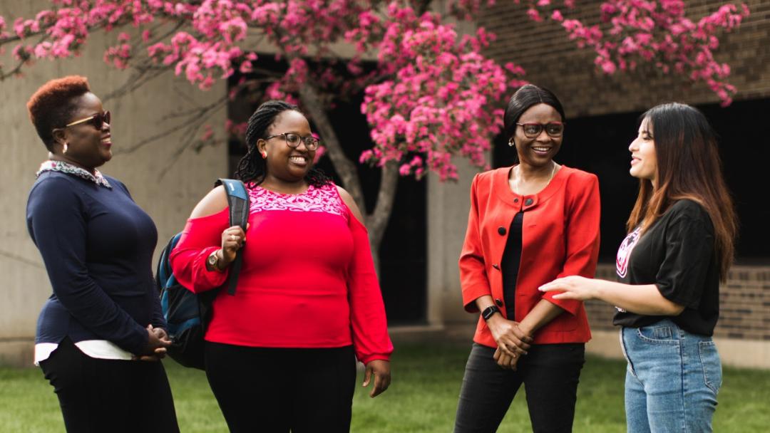 Four students outside Education Building