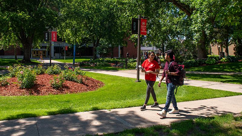 Two students walking on campus